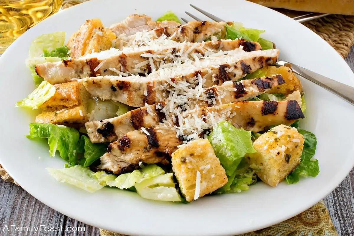 A vibrant Grilled Chicken Caesar Salad with fresh romaine, juicy chicken, and creamy dressing.